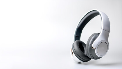 White metallic white wireless headphones in the air on side position provides copy space for text. background concept isolated white