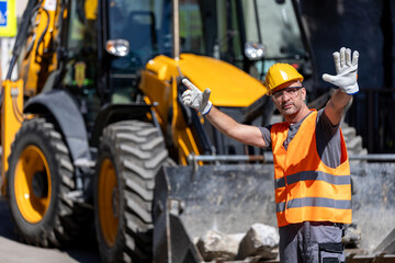 Construction worker directing traffic near heavy machinery at a busy job site during daylight hours