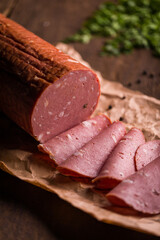 Delicious Sliced Bologna on Rustic Paper with Herbs
