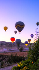 Hot air balloons fly in Cappadocia on an autumn morning.