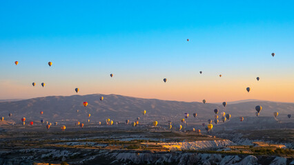 Hot air balloons fly in Cappadocia on an autumn morning.