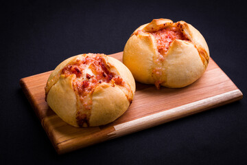 Delicious Stuffed Bread Rolls on Wooden Cutting Board