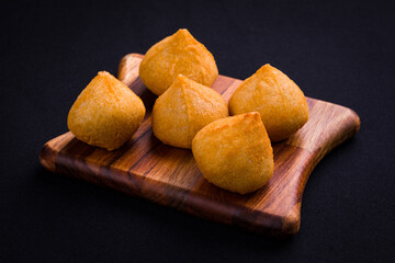 Delicious Brazilian Coxinha Snacks on a Wooden Board