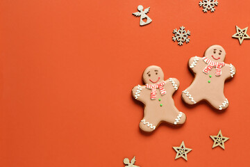 Christmas sweet gingerbread cookies and beautiful decorations on orange background