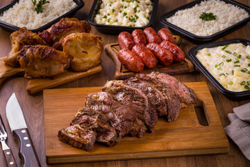 Delicious Grilled Meat Selection With Sausages and Side Dishes on Table