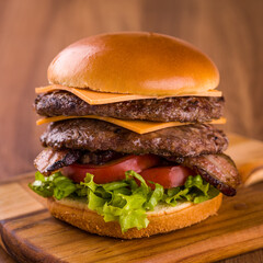 Delicious Double Cheeseburger With Fresh Toppings on Wooden Board