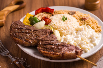 Delicious Grilled Picanha Meat with Vegetables and Rice on a Plate
