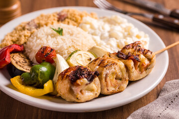 Delicious Grilled Chicken Skewers with Vegetables and Rice on Plate