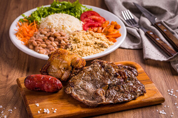 Delicious Brazilian BBQ with Traditional Sides on Wooden Table