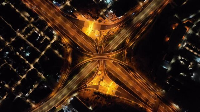 Aerial drone hyper lapse night video of urban elevated toll road junction and interchange overpass in National road and Attiki odos of Attica, Athens, Greece