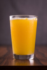 Refreshing Orange Juice Glass On Wooden Table With Condensation