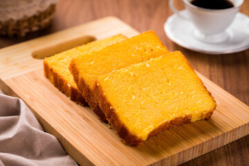 Delicious Homemade Cornbread Slices with Coffee on Wooden Table