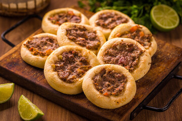 Delicious Middle Eastern Meat Pastries on Rustic Wooden Board
