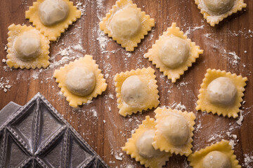 Handmade Ravioli On Wooden Surface With Flour Dusting