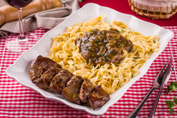 Delicious Pasta Dish with Beef and Mushroom Sauce Served on Table