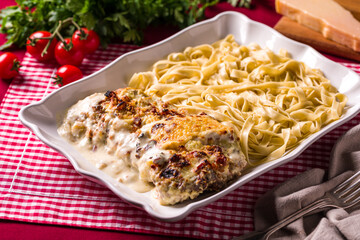 Italian Fettuccine and Cheese-Baked Dish on Red Checkered Tablecloth