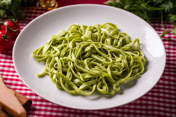 Delicious Green Spinach Pasta on Checkered Tablecloth