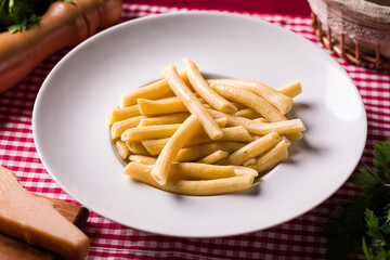 Delicious Plate of Penne Pasta on Red Checkered Tablecloth
