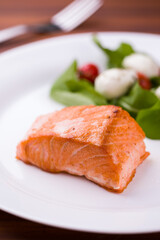 Delicious Grilled Salmon Fillet with Fresh Green Salad and Tomatoes