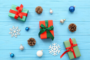 Christmas gift boxes and beautiful decorations on blue wooden background