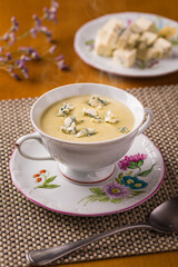 Elegant Soup Presentation With Creamy Cheese and Floral China