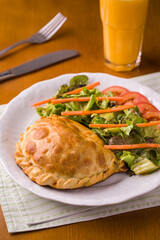 Delicious Homemade Calzone with Fresh Mixed Salad and Orange Juice