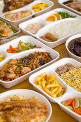Assorted Takeaway Meals in Disposable Containers on Wooden Table