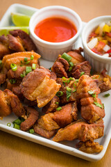Crispy Pork Belly with Spicy and Tangy Sauces on Plate