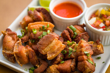 Crispy Pork Belly Chicharrón with Dipping Sauces on a Plate
