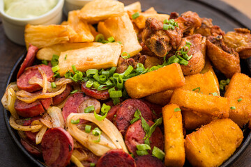 Delicious Brazilian Dish with Sausage, Chicken, and Fried Yuca