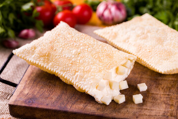 Delicious Brazilian Pastel With Savory Cheese Filling On Wooden Board