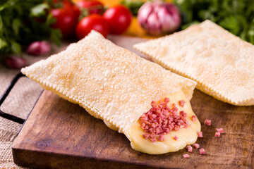 Delicious Brazilian Pastel with Ham and Melted Cheese Filling