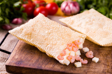 Crispy Brazilian Pastel Filled With Shrimp and Cheese on Wooden Board