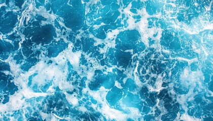 Vibrant turquoise ocean waves crashing in bright sunlight at the beachside