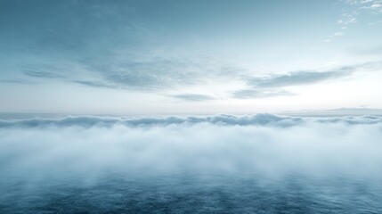 A panoramic view of a vast expanse of clouds stretching across the horizon with a soft, blue hue under a clear sky.