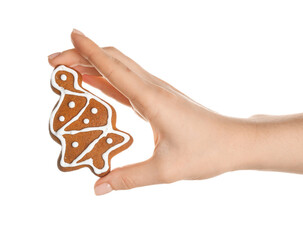 Female hand with sweet Christmas cookie on white background