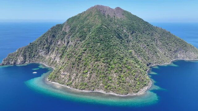 The scenic island of Komba lies about 70 km north of the island of Lembata in the Lesser Sunda Islands of Indonesia. This remote island, surrounded by reef, is an active volcano that often erupts.