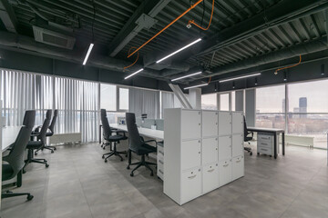 Modern office interior indoors with panoramic windows and city views. Ergonomic chairs, white furniture.