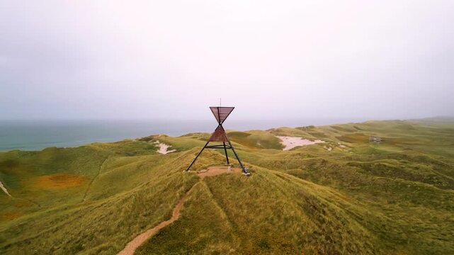 Drone shot of unlighted beacon seamark in the dunes of Husby Klit, on the west coast of Jutland,  Denmark