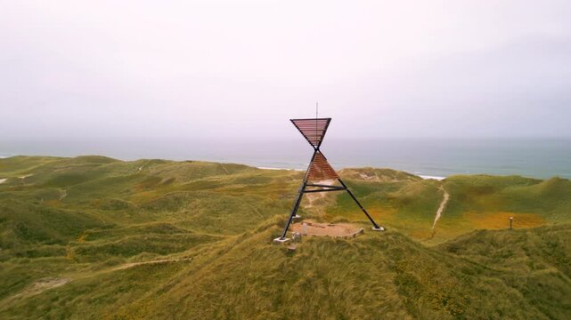 Drone shot of unlighted beacon seamark in the dunes of Husby Klit, on the west coast of Jutland,  Denmark