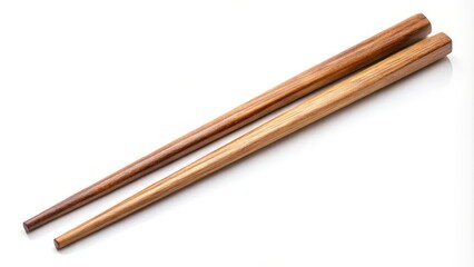 Two wooden chopsticks are lying on a white background, casting subtle shadows