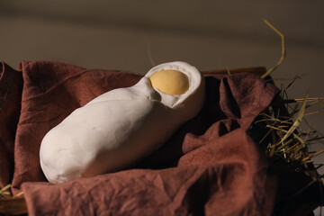Manger with baby and hay on light wooden background. Concept of Christmas story