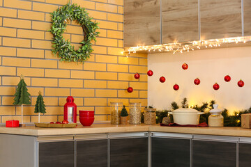 Utensils with Christmas decor on counters in kitchen