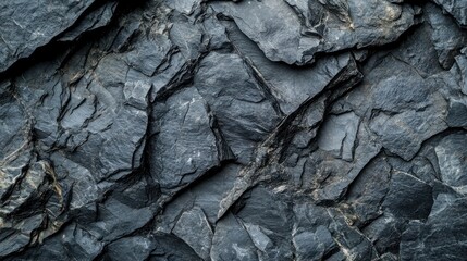 Close-up of textured slate rock surface showcasing natural patterns and colors.