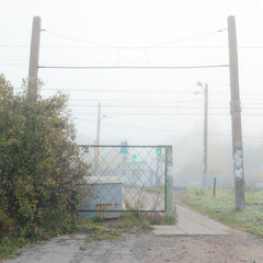 Fototapeta premium A pedestrian crossing over a railway track with traffic lights indicating it is safe to cross, ensuring safety for walkers.