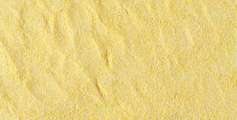 Corn polenta pile background and texture, uncooked, top view, 