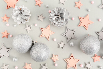 Beautiful composition with Christmas balls, decorative stars, beads and silver cones on grey...