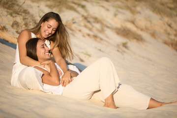 Lesbian couple enjoys a heartfelt moment on a Spanish beach
