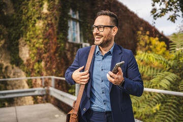 businessman stand on the terrace and left voice mail on mobile phone