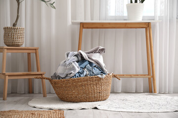 Wicker basket full of dirty clothes in laundry room